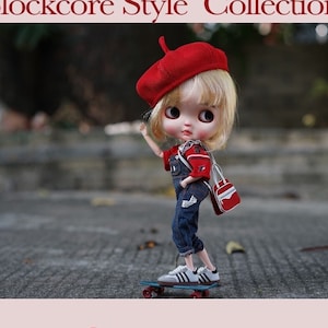 May include: A red and white striped knit top with a red knit bra underneath. The top has a white number "3" on the sleeve. The bra has thin straps.  The image also includes a doll wearing a red beret, a red and blue shirt, and blue jeans. The doll is riding a skateboard. The text "sugar a super agent" and "sugara 2022 fw" is also included in the image.