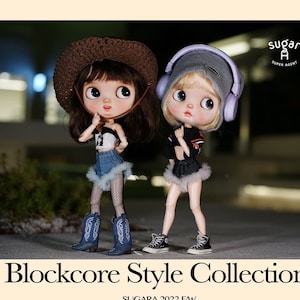 May include: Two dolls wearing different outfits. One doll is wearing a denim skirt with a white top and a cowboy hat. The other doll is wearing a black crop top with a denim skirt and headphones. The dolls are standing on a sidewalk at night. The text "Blockcore Style Collection" and "Sugara 2022 F/W" is below the dolls. Below the text are two more outfits: a white crop top with a denim skirt and a black crop top with a denim skirt.