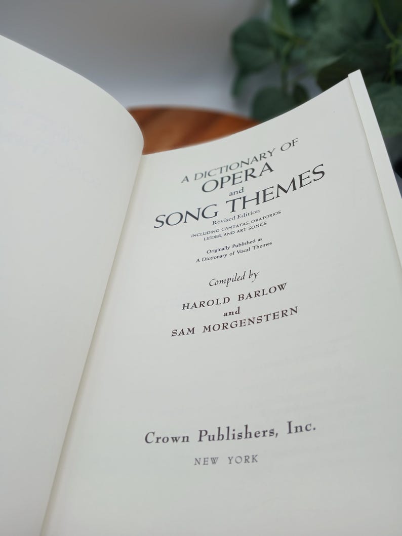 May include: Open book titled "A Dictionary of Opera and Song Themes" by Harold Barlow and Sam Morgenstern. The book is published by Crown Publishers, Inc. in New York. The pages are off-white with black text.