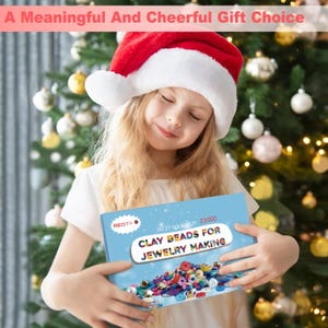 May include: A young person wearing a Santa hat holds a blue box labeled "CLAY BEADS FOR JEWELRY MAKING." The box features colorful beads. The text "A Meaningful And Cheerful Gift Choice" is at the top.