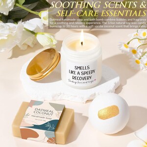 May include: A lit candle in a clear glass jar with a label reading "SMELLS LIKE A SPEEDY RECOVERY Sending love and hugs", a gold lid, a rectangular bar of oatmeal coconut handmade soap, and a white bath bomb with a gold shimmer accent.