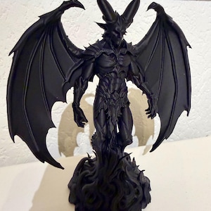 May include: A matte black figurine of a winged demon with large curved horns, muscular build, and pointed ears. The figure stands atop a base sculpted to resemble swirling smoke or flames, with expansive, detailed bat-like wings spread wide.