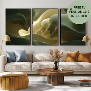 May include: Three framed abstract art prints with a flowing, organic design in shades of green and yellow. The artwork is displayed above a cream-colored sofa with blue and orange throw pillows. A round wooden coffee table and a gold ottoman complete the living room setting.