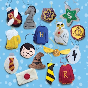 May include: A collection of felt ornaments in various shapes and colors. Includes a chess piece, a star with the letter "S", a beer mug, a sweater with the letter "H", a golden snitch, a lightning bolt, and a letter.