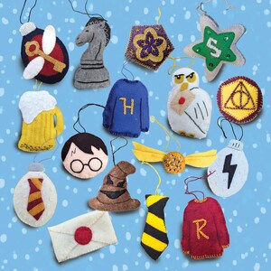May include: A collection of felt ornaments in various shapes and colors. The ornaments include a chess piece, a sweater with an "H", a star with an "S", a beer mug, a character with glasses, a hat, a tie, a golden snitch, and a lightning bolt.