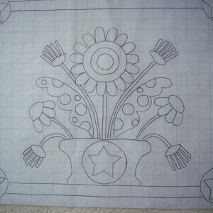 May include: A black and white line drawing of a flower arrangement in a pot. The flowers are stylized and have a whimsical look. The pot has a star in the center.