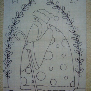 May include: A black and white line drawing of Santa Claus with a staff, wearing a dotted robe and a hat. He is standing under a wreath of holly with stars above. The word "PEACE" is written below him.