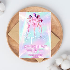 May include: A birthday invitation with a holographic background and the text "Sophia's 8th Birthday." The invitation features three doll-like figures and event details. The invitation is on a wooden tray with a brown envelope.