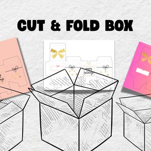 Puede incluir: Imagen de un diseño de caja para cortar y plegar con el texto "CUT & FOLD BOX". El diseño incluye plantillas para cajas, con fondos degradados rosa y amarillo, y un fondo blanco. Las plantillas presentan lazos dorados y el texto "happy holidays".