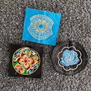 May include: A set of three ceramic mugs with a speckled, matte finish. The mugs are in shades of cream, light gray, and dark gray. Each mug has a simple, minimalist design, perfect for coffee or tea.