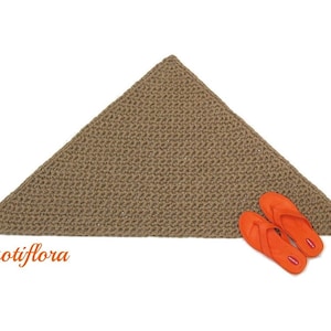 May include: A triangular brown crocheted rug with two orange flip flops on top of it. The rug is made of a thick, textured yarn.