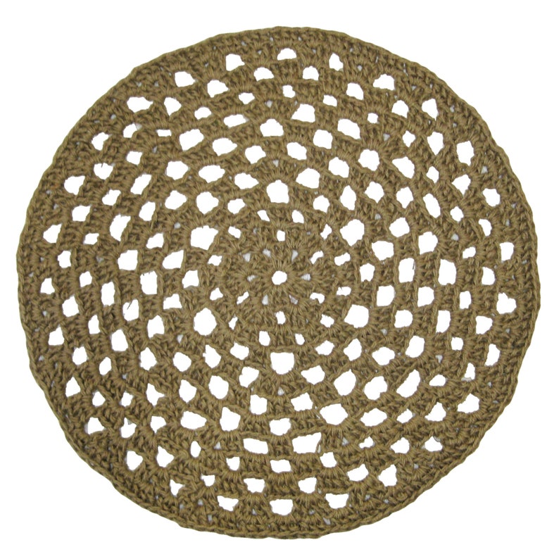 May include: A round, brown, crocheted jute rug with a circular pattern. The rug has a natural, earthy tone and is made of woven fibers.