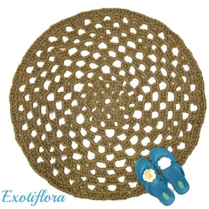 May include: A round, brown, crocheted jute rug with a circular pattern. The rug is made of natural fibers and has a rustic, bohemian style.