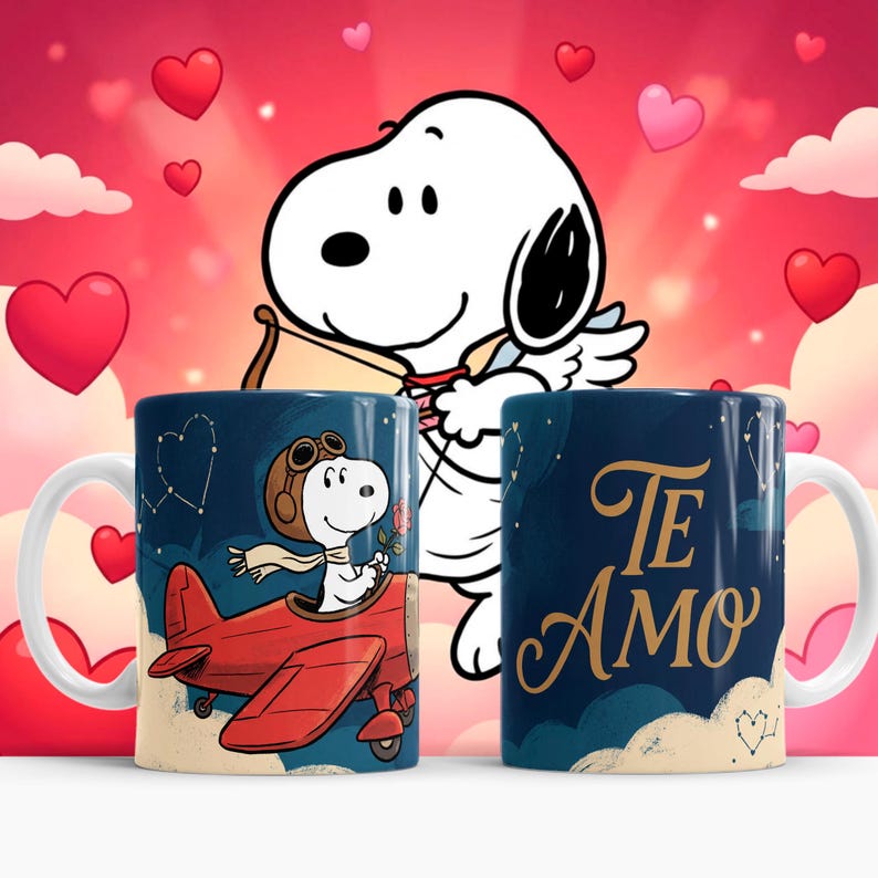 May include: Two ceramic mugs with white handles. One mug features Snoopy in a red airplane, the other says "Te Amo" in gold lettering. The background is a Valentine's Day theme with hearts and Snoopy as Cupid.