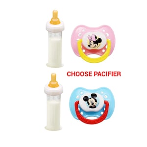 May include: Two baby bottles with yellow nipples and white bottles filled with a milky liquid. Two pacifiers are also shown, one pink with a Minnie Mouse design and the other blue with a Mickey Mouse design. The text "CHOOSE PACIFIER" is in red.