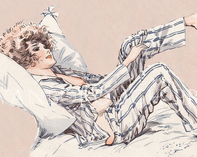 May include: A woman in striped pyjamas lies on a bed with a white pillow. Her hair is curled and she is looking to the side.