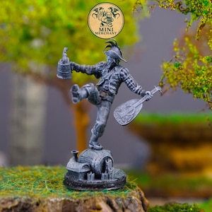 May include: A detailed miniature figurine of a jovial figure, holding a beer stein and a lute. The figure is dressed in a hat and patterned clothing, standing atop a barrel-shaped base. The figurine is grey and set against a blurred background.