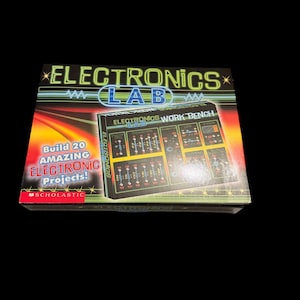 May include: Electronics Lab kit box with the text "ELECTRONICS LAB" in green and blue. The box features a graphic of an electronics workbench and the text "Build 20 AMAZING ELECTRONIC Projects!"