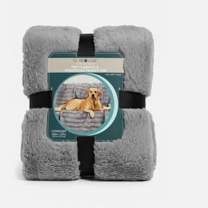 May include: A folded gray faux fur pet blanket and furniture protector secured with a black band. The product label features the text Brentwood Pet Blanket & Furniture Protector and an image of a golden dog on a sofa, measuring 60 inches by 75 inches.