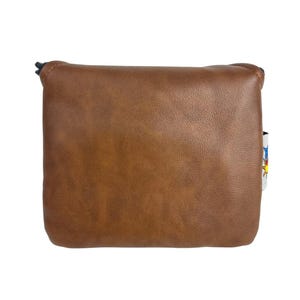 May include: A brown leather golf club head cover with a zipper closure.