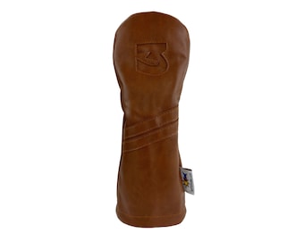 May include: A brown leather golf club head cover with a stitched design and a logo that says "3".