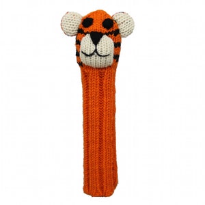 May include: Orange and black knitted golf club head cover with a tiger face. The tiger has white ears, a white nose, and black eyes.