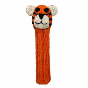 May include: Orange and black knitted golf club head cover with a tiger face. The tiger has white ears, a white nose, and black eyes.