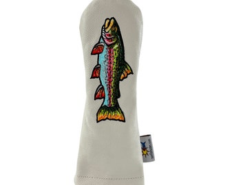 May include: A light gray golf club head cover with an embroidered colorful fish design. The fish has red, blue, green, and yellow details. A small tag with text is attached to the side.
