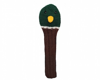 Puede incluir: Un cubrecabezas de palo de golf de punto verde y marrón con una cara de pato. El pato tiene ojos negros, un pico amarillo y una franja blanca alrededor de la cabeza.