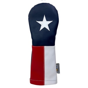 May include: A blue, red, and white golf club head cover with a white star in the center. The cover is designed to look like the Texas state flag.