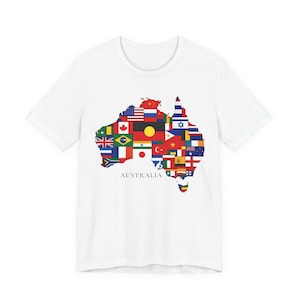 May include: White t-shirt with a map of Australia made up of different national flags. The word "AUSTRALIA" is printed underneath the map. The shirt has a crew neck and short sleeves.
