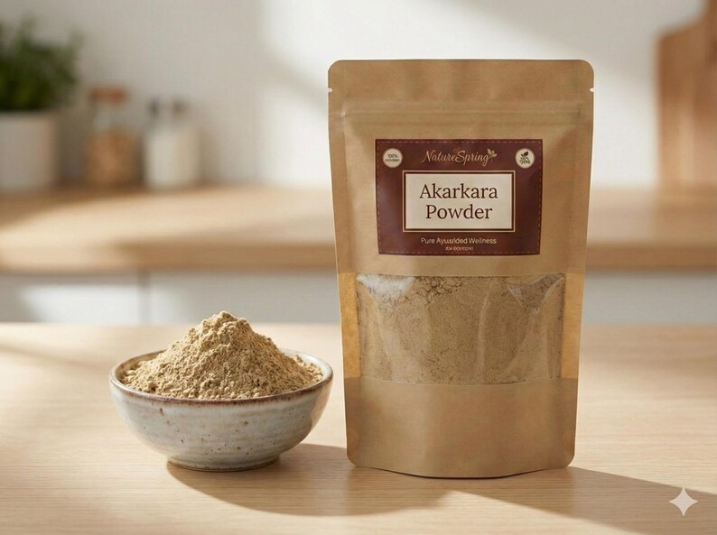 May include: A brown paper bag and a small ceramic bowl filled with Akarakara powder. The bag has a clear window and a label that reads "Akarakara Powder" and "Pure Ayurvedic Wellness". The bowl is light brown and sits on a wooden surface.