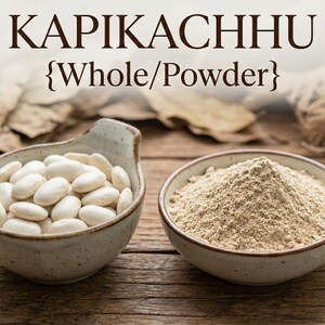 May include: Two ceramic bowls on a wooden surface. One bowl contains white beans, the other contains a light brown powder. The text "KAPIKACHHU {Whole/Powder}" is at the top of the image.