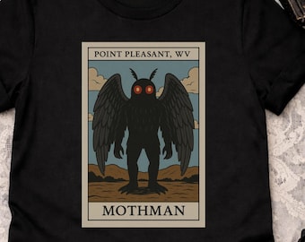 May include: Black t-shirt featuring a graphic of the Mothman, a cryptid from Point Pleasant, WV. The design includes the text "POINT PLEASANT, WV" and "MOTHMAN" with a stylized illustration of the creature with red eyes and large wings.