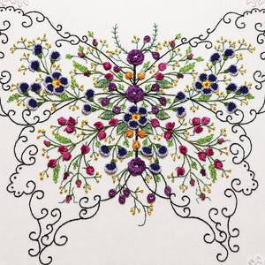 May include: An embroidery design featuring a butterfly shape outlined in black thread, filled with intricate floral patterns in purple, pink, green, and yellow. The composition includes small white lace accents in the corners of the fabric.