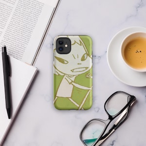 May include: A green phone case featuring a cartoon character illustration. The design has a light green background with a white and light green character. The phone case is on a white marble surface.