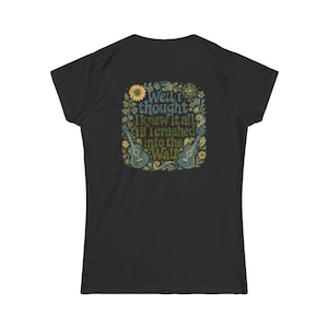 May include: Black t-shirt with a floral design and the text "Well I thought I knew it all til I crashed into the Wall." The design includes two guitars and a sunflower. The shirt is made of a soft material.