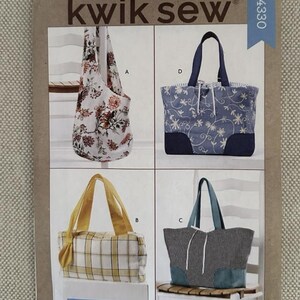 May include: A sewing pattern titled "kwik sew" featuring four different bag designs. The bags include a floral tote, a blue floral tote, a yellow plaid tote, and a black and white checkered tote with teal accents. The pattern number is K4330.