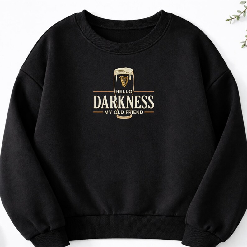 May include: Black sweatshirt with a graphic featuring a pint of beer with the text "HELLO DARKNESS MY OLD FRIEND" in a gold and white design. The sweatshirt is a crew neck style.