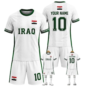 May include: White soccer uniform with green trim, featuring the word "IRAQ" and the number "10" in green. The uniform includes the Iraqi flag and is displayed on a mannequin and a smaller version on a hanger.