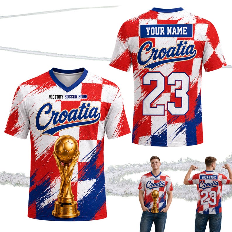 Pu&ograve; includere: Una maglia da calcio della Croazia con un design a scacchi rosso, bianco e blu. La parte anteriore presenta la scritta "Croatia", un trofeo dorato e il testo "Victory Soccer 2026". Il retro mostra il numero 23 e uno spazio per un nome.