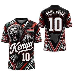 May include: A black, red, and green V-neck jersey featuring a roaring lion graphic, the text Kenya, and the number 10 on the front. The back displays the text Your Name, the number 10, and a map outline of Kenya with geometric patterns throughout.