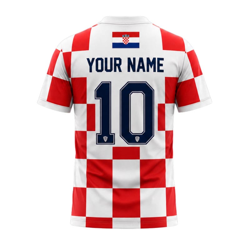 May include: A white and red checkered soccer jersey with the Croatian flag at the top. The jersey has the number 10 in navy blue and the text "YOUR NAME" above it. The jersey is short-sleeved.