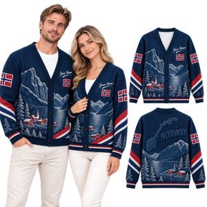 May include: A navy blue V-neck cardigan featuring a Norwegian landscape with mountains, a lake, and red houses. The sleeves have red, white, and blue stripes and a Norwegian flag patch. The back displays a map of Norway and the text "NORWAY".
