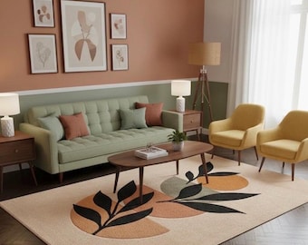 May include: A living room with a sage green sofa, two yellow armchairs, and a patterned rug. The rug features black leaf designs and orange and green geometric shapes. The walls are painted in shades of peach and green, with framed artwork.
