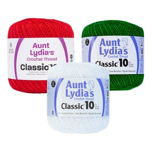 May include: Three spools of Aunt Lydia's Classic 10 crochet thread in red, green, and white. The thread is 100% mercerized cotton.
