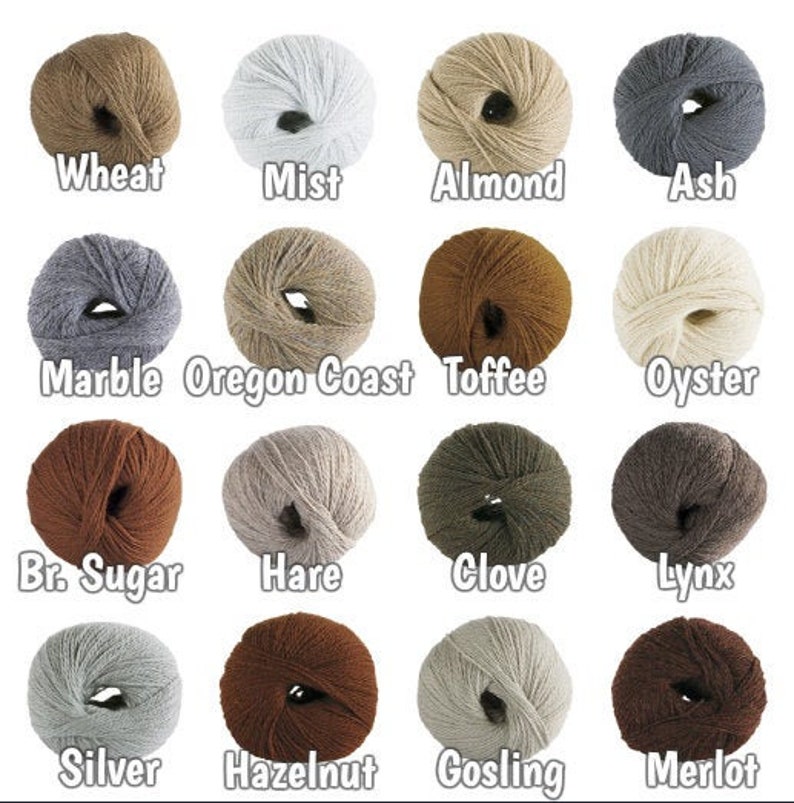 May include: A colour chart of yarn samples in various shades of brown, grey, beige, and white. The yarn is arranged in a grid with labels below each sample, including "Wheat", "Mist", "Almond", "Ash", "Marble", "Oregon Coast", "Toffee", "Oyster", "Br. Sugar", "Hare", "Clove", "Lynx", "Silver", "Hazelnut", "Gosling", and "Merlot".