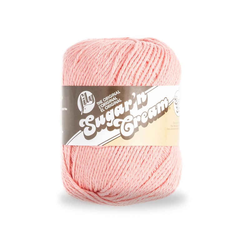 May include: A pink ball of Lily Sugar'n Cream yarn. The label reads "The Original/L'Original/El Original" and "Sugar'n Cream".