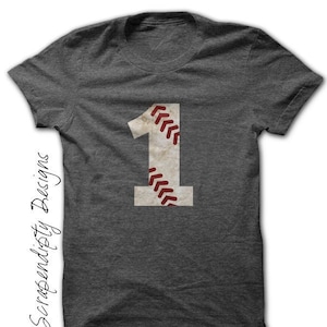 May include: A dark gray t-shirt with a white baseball-themed number one printed on the front. The number one has red stitching.
