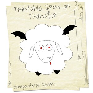 K&ouml;nnte beinhalten: Druckbarer B&uuml;geltransfer mit einem wei&szlig;en Schaf mit schwarzen Fledermausfl&uuml;geln, roten Augen und Z&auml;hnen. Der Text "Printable Iron on Transfer" befindet sich oben im Bild. Der Text "Scrapendipity Designs" befindet sich unten im Bild.